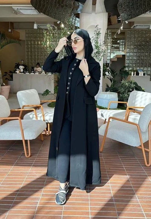 woman wearing a classic black blazer made of smooth crepe fabric in a modern indoor setting