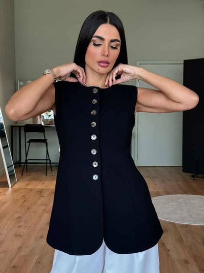 Black sleeveless vest in crepe fabric with front buttons, styled for layering over dresses or abayas.