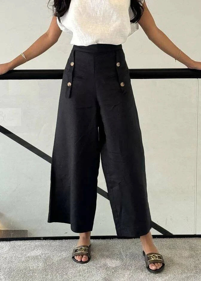 Black linen pants with front button details, wide-leg and breathable fabric for casual elegance
