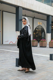 Modern black abaya with white stitching in premium mokado fabric for stylish comfort