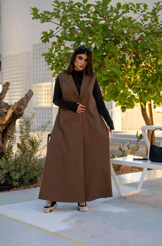 woman wearing chino brown cropped trench over sleeveless dress outdoors