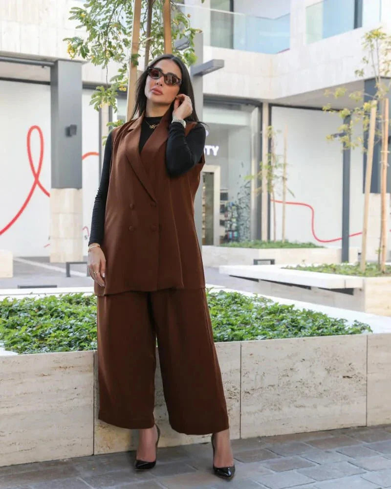 Woman wearing camel vest and wide-leg pants set with lapel collar in outdoor urban setting