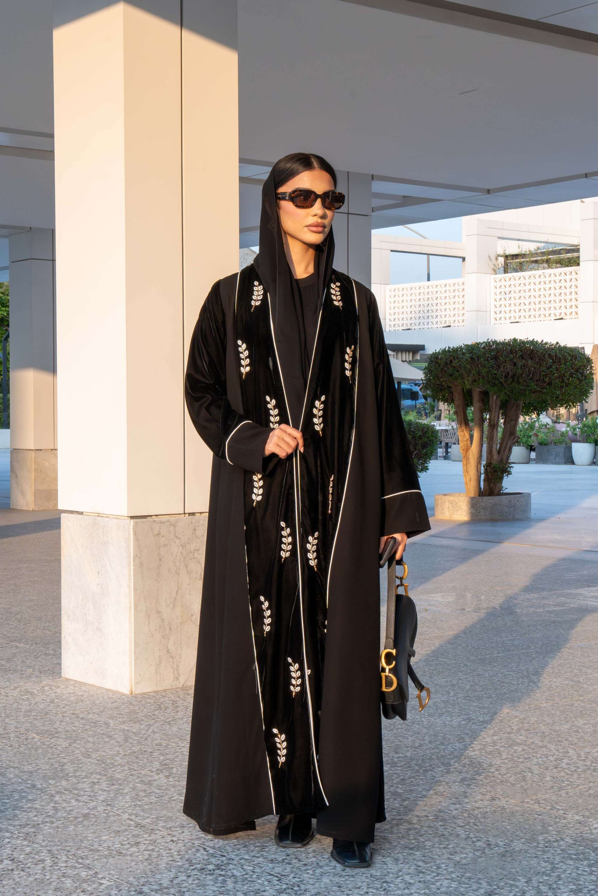 Elegant black Veloura Abaya with gold embroidery and velvet accents, perfect for special occasions.
