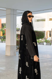 Black Velvet Bloom abaya with elegant embroidery and loose bisht-style cut, combining velvet and crepe fabrics for a luxurious look