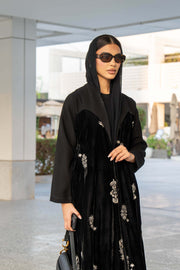 Black Velvet Bloom abaya with elegant embroidery and loose bisht-style cut, combining velvet and crepe fabrics for a luxurious look