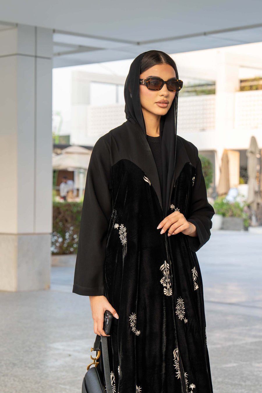 Black Velvet Bloom abaya with elegant embroidery and loose bisht-style cut, combining velvet and crepe fabrics for a luxurious look