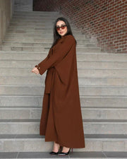 Woman wearing a freesize auburn blazer abaya in deep brown crepe with a structured, comfortable fit and double-breasted front.