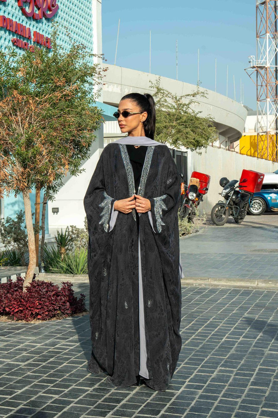 Elegant black Zein abaya in flowing free-size cut with silver embroidery on front and cuffs, perfect for evening wear