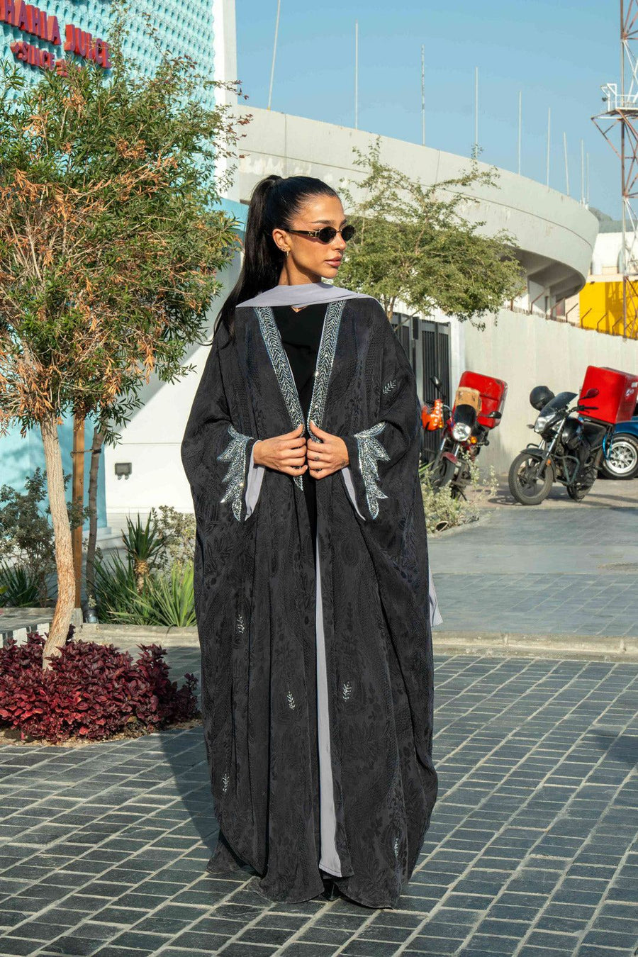 Elegant black Zein abaya in flowing free-size cut with silver embroidery on front and cuffs, perfect for evening wear