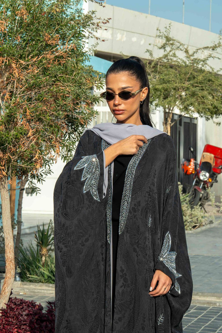 Elegant black Zein abaya in flowing free-size cut with silver embroidery on front and cuffs, perfect for evening wear