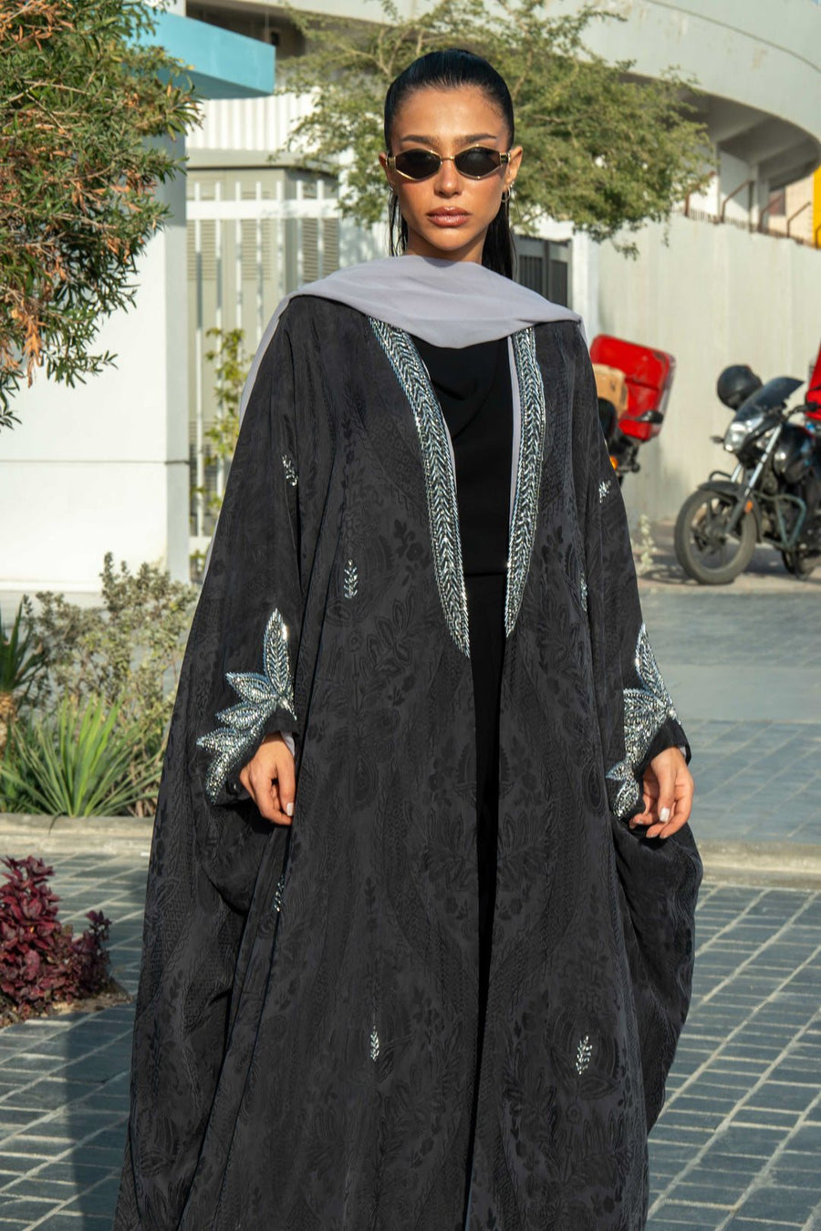 Elegant black Zein abaya in flowing free-size cut with silver embroidery on front and cuffs, perfect for evening wear