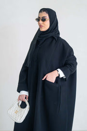 luxurious black crepe abaya with loose fit and elegant design for formal and everyday wear