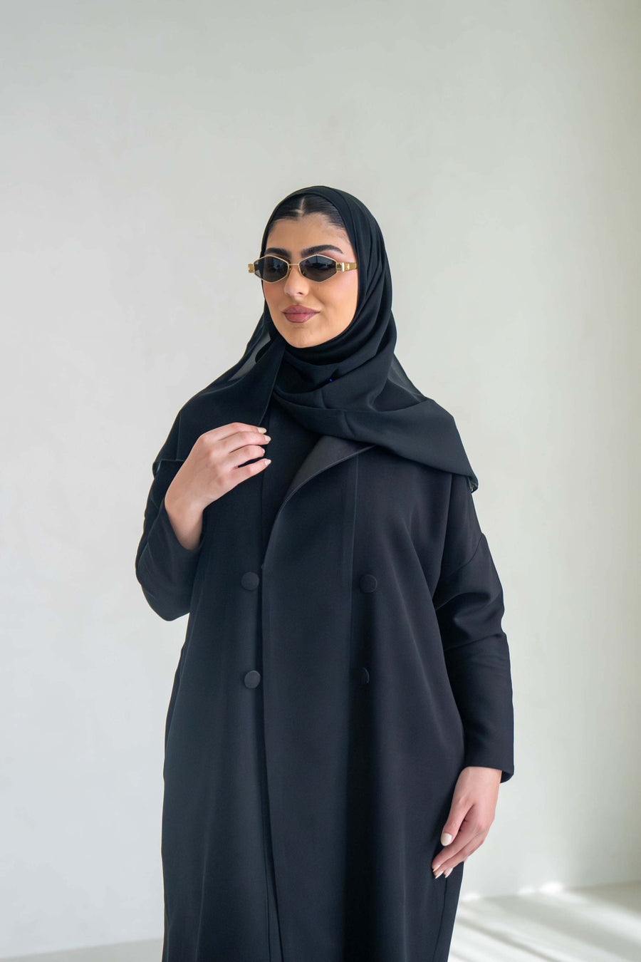 sleek black abaya with two-button front closure and soft mokado lining for everyday elegance