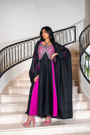 Black dress with magenta panels and butterfly-style embroidered neckline paired with matching black bisht with contrast piping