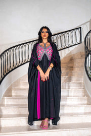 Black dress with magenta panels and butterfly-style embroidered neckline paired with matching black bisht with contrast piping