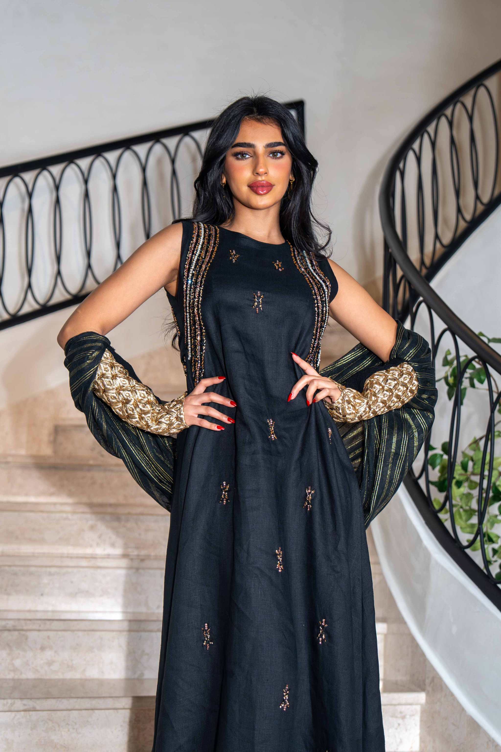 Elegant simple black dress with delicate golden embroidery, sleeveless design, and comfortable lightweight fabric.