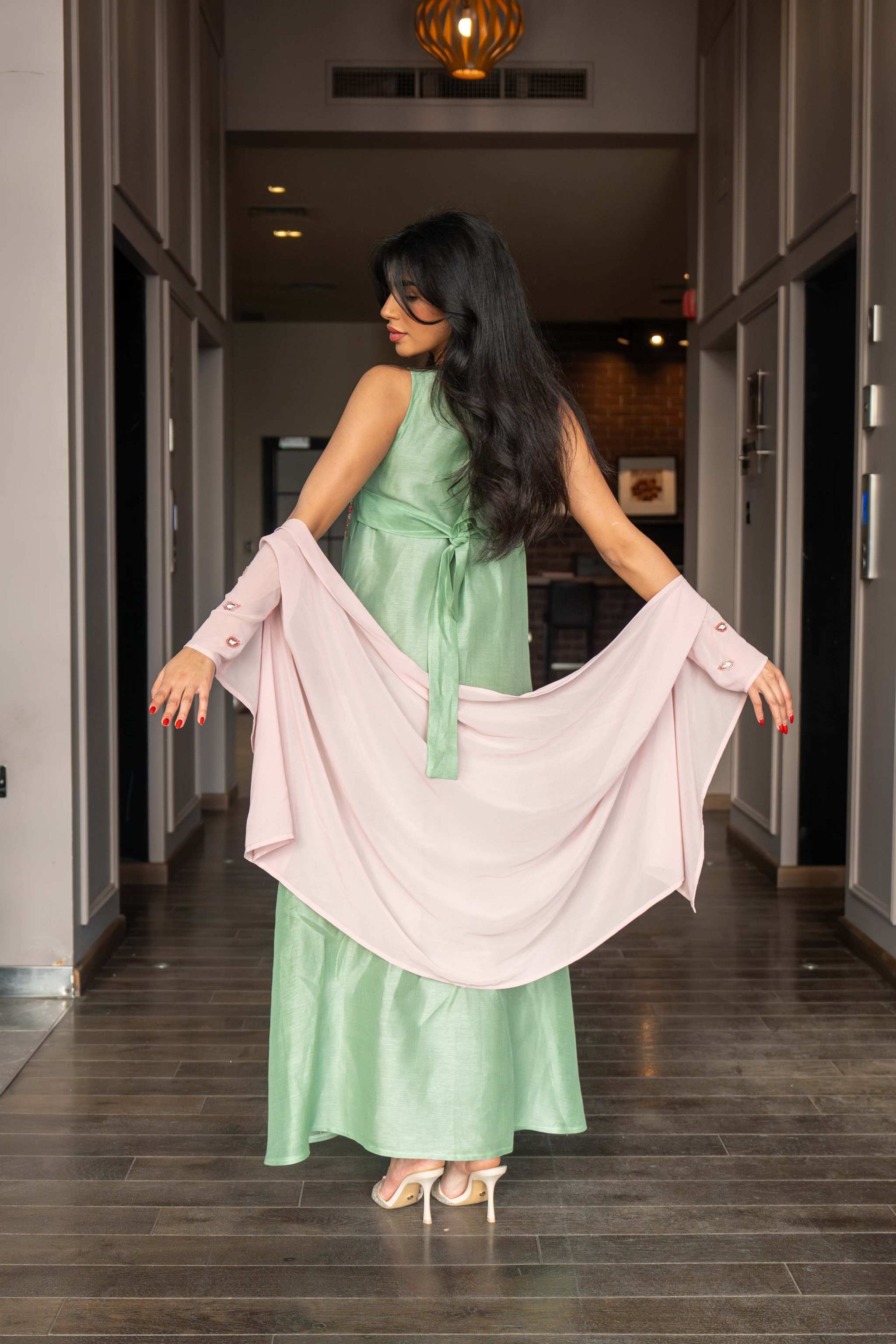 soft pastel green one-piece dress with floral embroidery and flowing blush pink cape sleeves for spring and summer