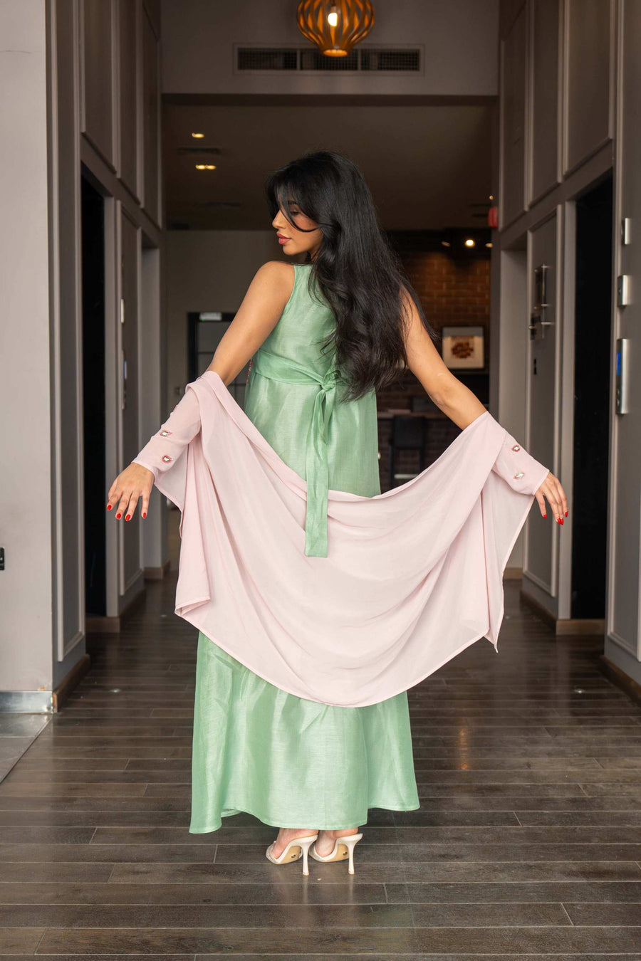 soft pastel green one-piece dress with floral embroidery and flowing blush pink cape sleeves for spring and summer