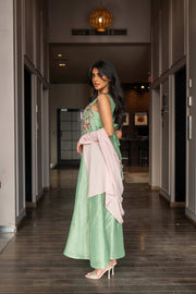 Soft pastel green one-piece dress with floral embroidery and flowing blush pink cape sleeves
