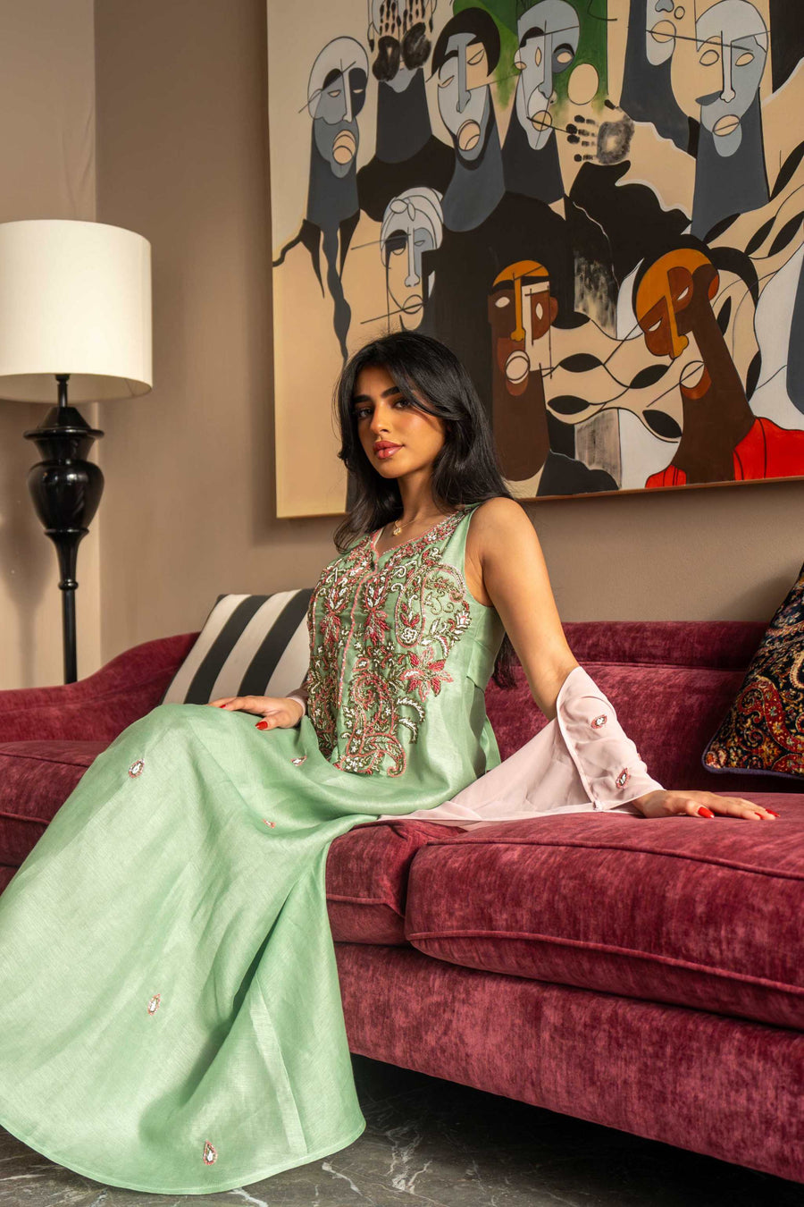 Soft pastel green one-piece dress with floral embroidery and blush pink cape sleeves, perfect for spring and summer.