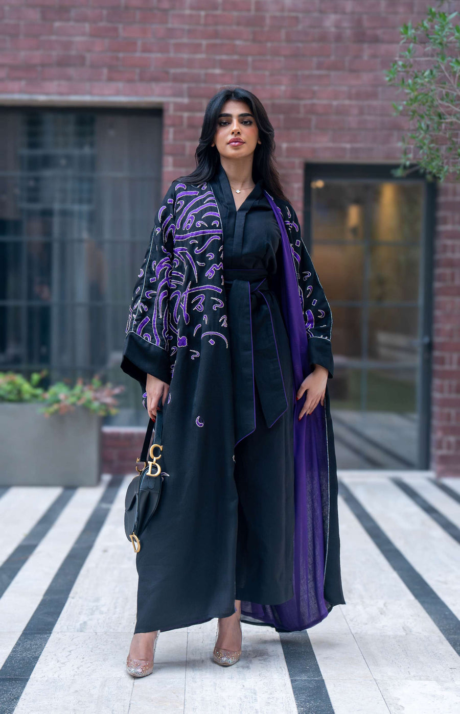 Elegant black bisht with purple chiffon lining and intricate purple Arabic calligraphy embroidery.