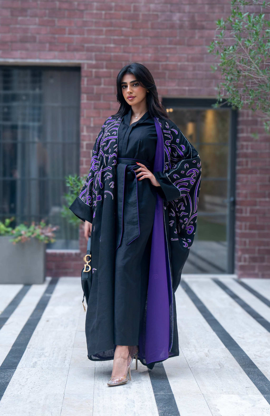 Elegant black bisht with purple chiffon lining and intricate purple Arabic calligraphy embroidery.