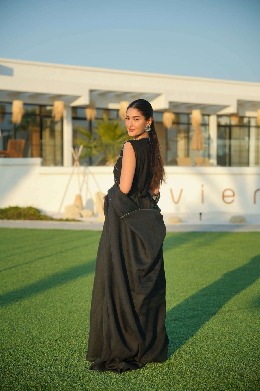 Elegant black abaya with delicate detailing layered over a shimmering silver and navy inner piece, perfect for evening occasions