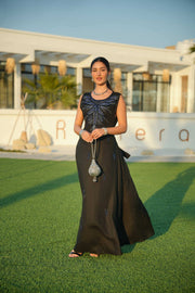 Elegant black abaya with delicate detailing layered over a shimmering silver and navy inner piece, perfect for evening occasions