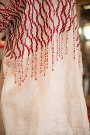 Beige bisht with bold red embroidery and intricate organic patterns on shoulders and sleeves