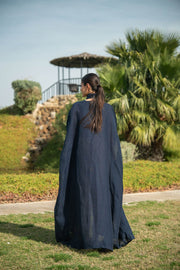 Elegant navy blue bisht with beige lining and delicate piping worn outdoors