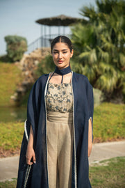 Elegant navy blue bisht with beige lining and delicate piping, worn as a flowing outer layer for day or evening occasions
