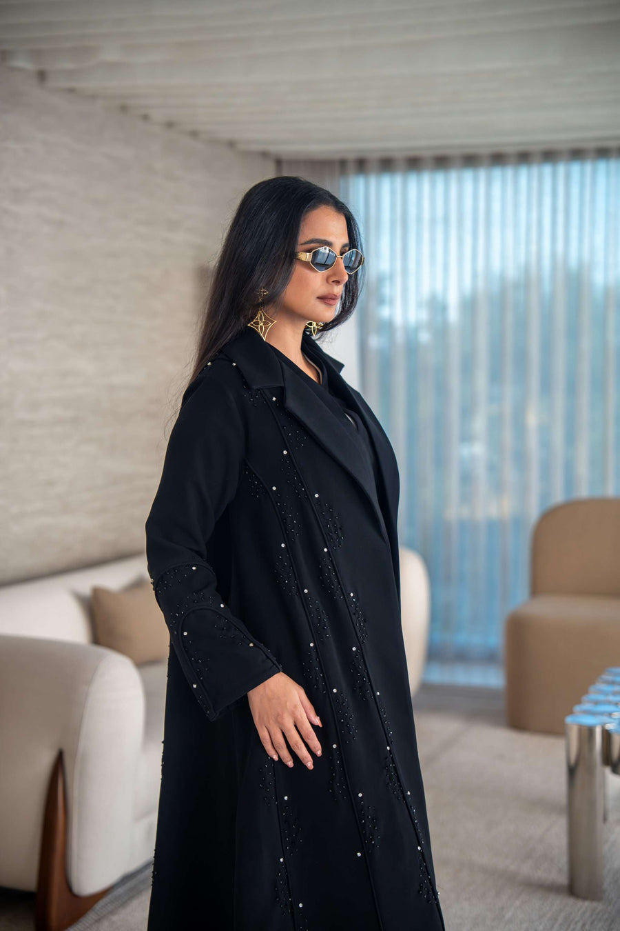 Velira black crepe abaya with delicate dot pattern embroidery and flowing elegant silhouette.