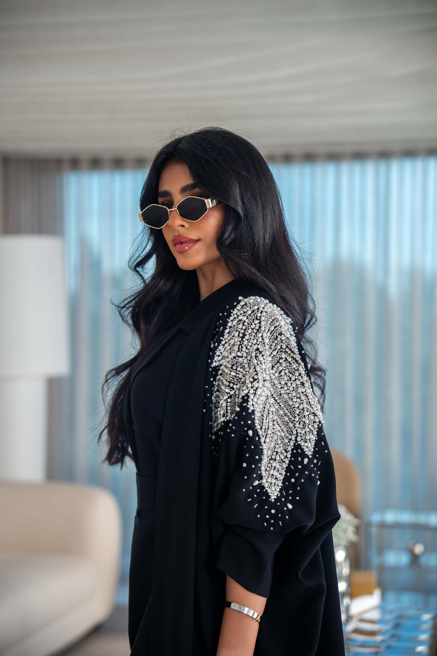 Elegant black crepe abaya with silver leaf embroidery on the shoulder and flowing fabric design