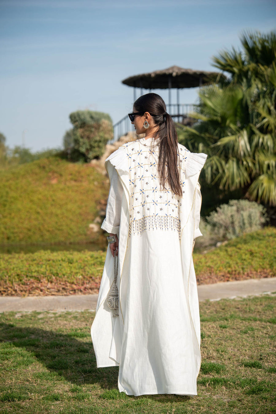 Elegant white abaya with intricate hand embroidery and flowing fabric, perfect for special occasions and everyday wear