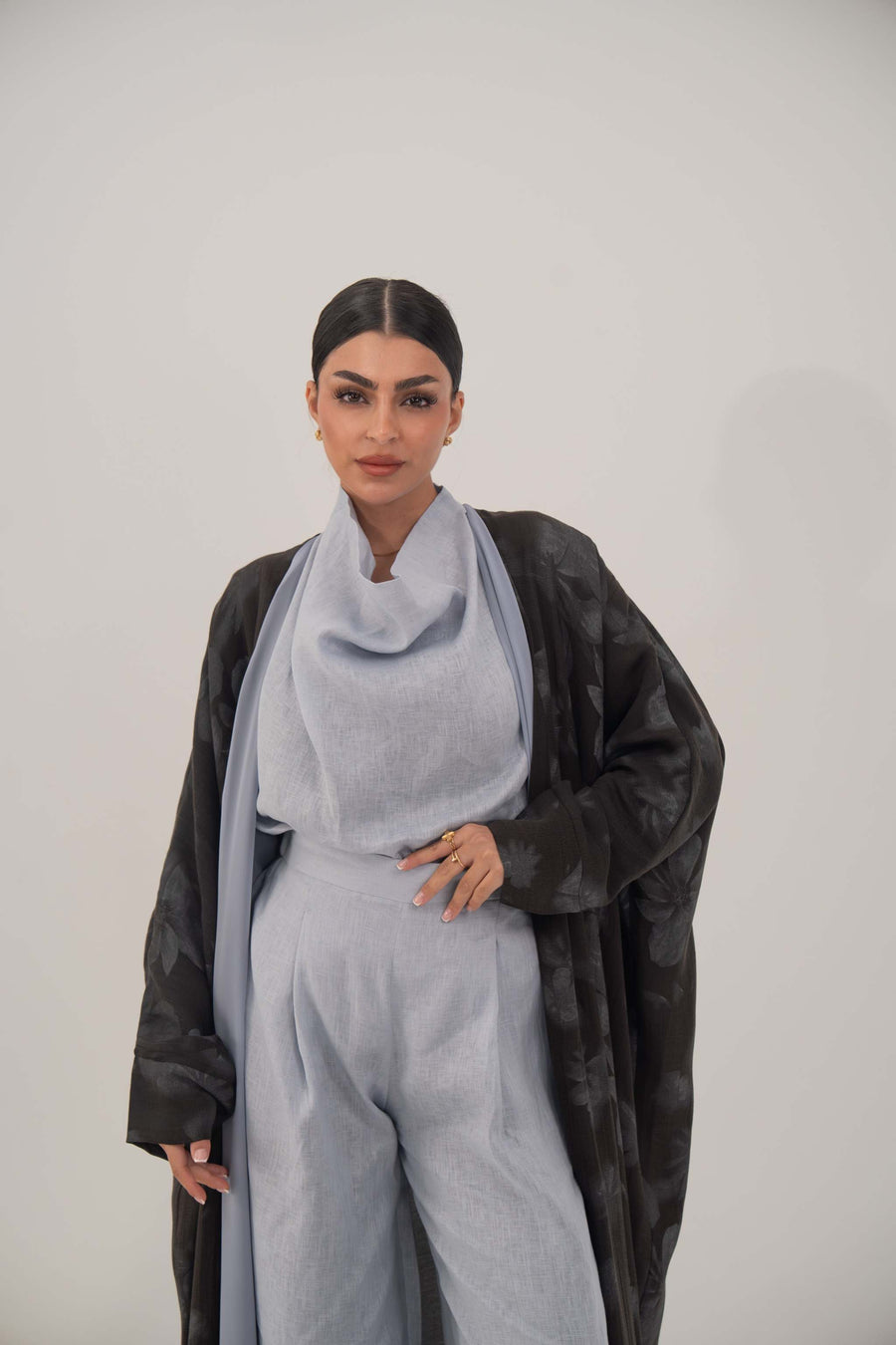 Elegant dark-toned silk abaya with relaxed wide cut, open front, soft lapel, and subtle pattern for graceful, lightweight comfort