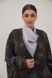 Silk abaya with wide relaxed cut, open front, soft lapel, long sleeves, subtle dark pattern, and soft sheen fabric.
