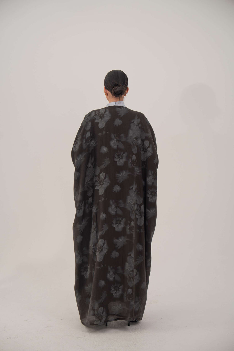 Silk Selva abaya with wide cut and subtle dark floral pattern, open front and long sleeves.