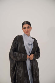 Elegant silk Selva abaya with a relaxed wide cut, open front, soft lapel, long sleeves, and subtle dark floral pattern.