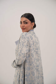 Woman wearing a lightweight jacquard silk open-front abaya with a soft floral pattern and simple lapel design
