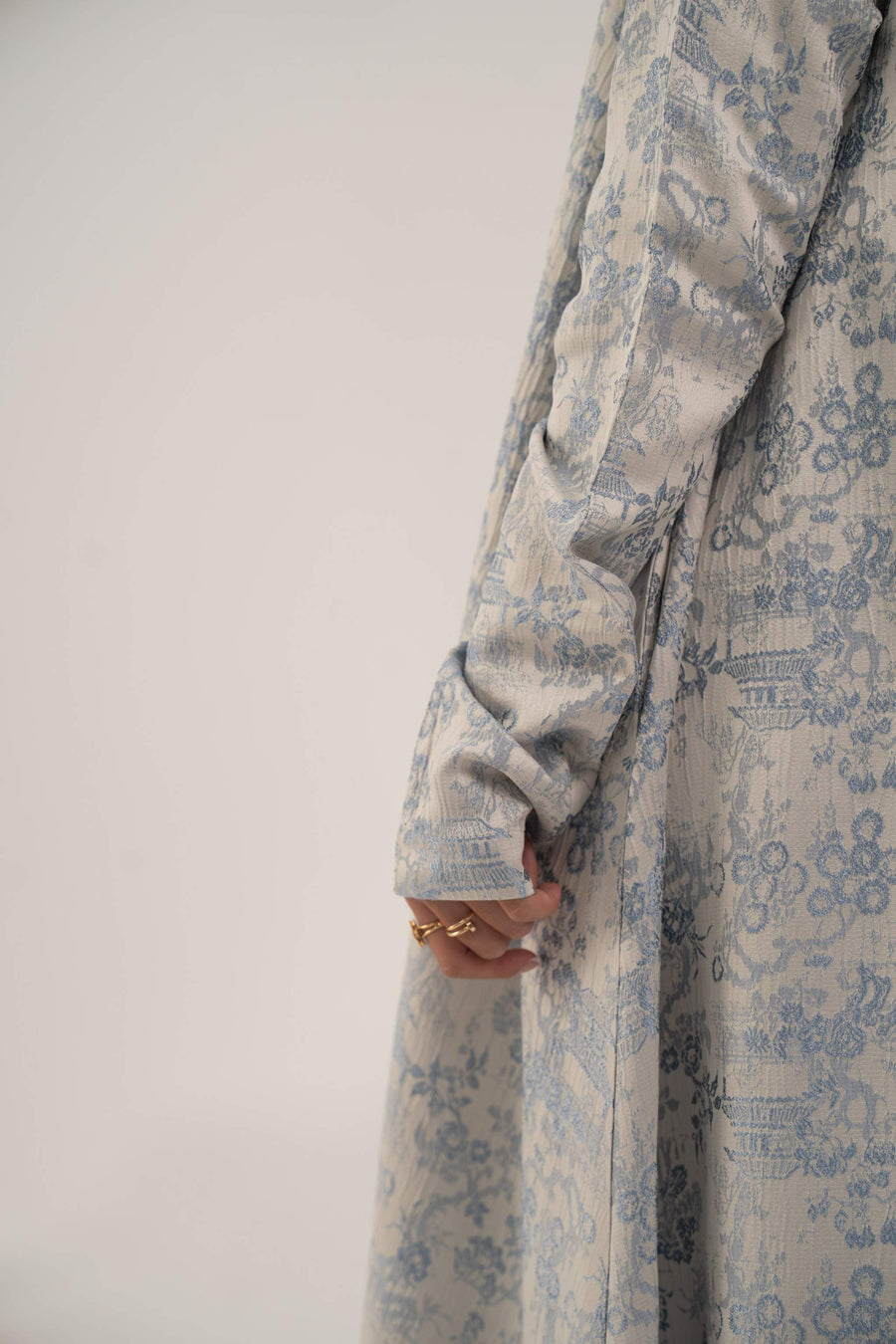 close-up of jacquard silk abaya sleeve with soft elegant pattern in blue and beige