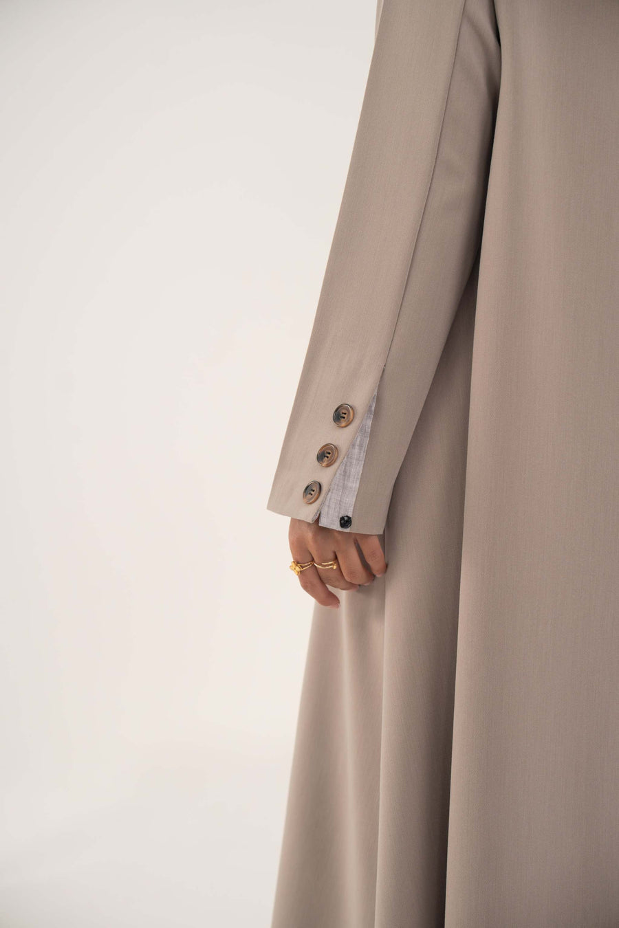 Light taupe beige blazer abaya sleeve detail with brown marbled buttons on lightweight crepe fabric