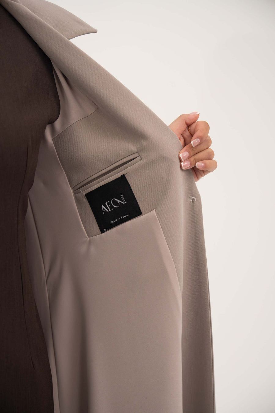 inside view of light taupe beige blazer with hidden inner pocket and notched collar