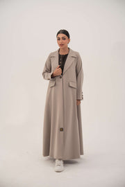 woman wearing light taupe beige blazer with notched collar and single front button standing against white background