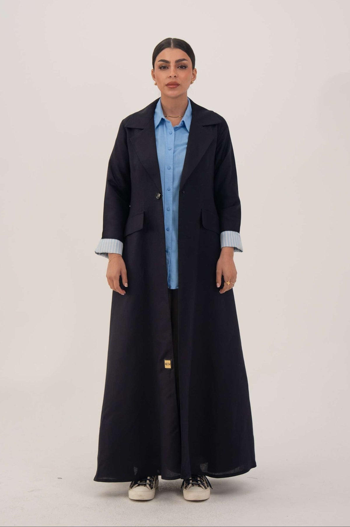 Abaya made from soft linen blend with longline blazer cut, deep navy tone, and folded blue pinstriped cuffs.
