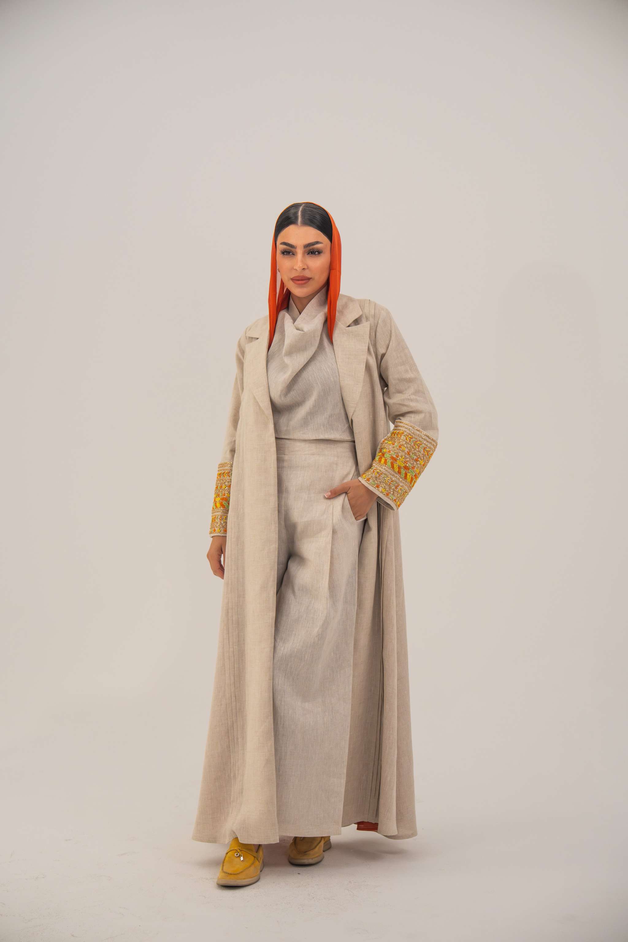 Beige linen blend abaya with tailored blazer cut, vibrant orange and gold embroidery on sleeves, and orange chiffon lining - sophisticated abaya