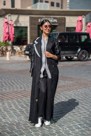 Black Blazer Abaya with sharp lapels and bold white piping, combining tailored sophistication with modern street style for professional and casual wear.