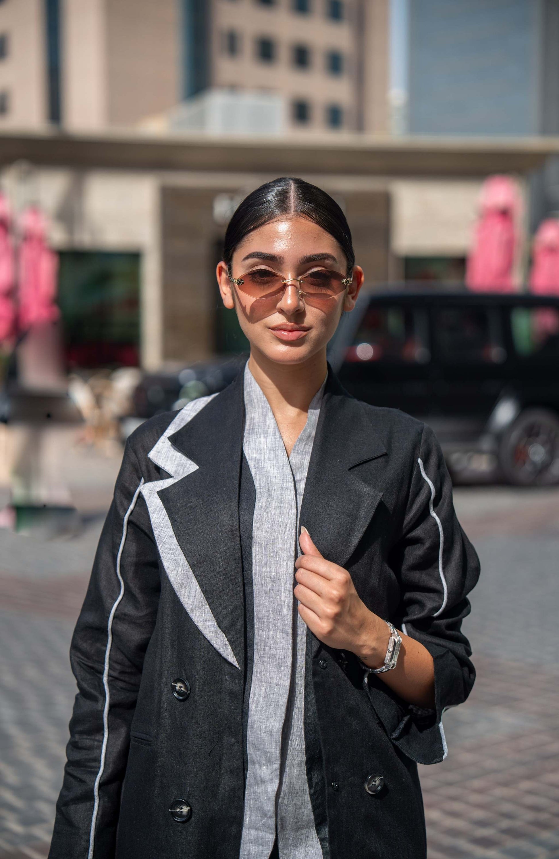 Black blazer abaya with sharp lapels and white piping, combining tailored sophistication with modern street style.