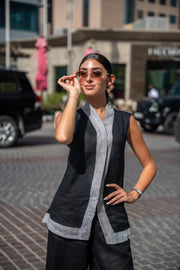 woman wearing black and gray mist vest with sunglasses standing outdoors