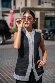 Woman wearing stylish black and gray Mist Vest with sunglasses outdoors
