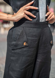 close-up of black Mist Pant with buttoned pockets and high waist design